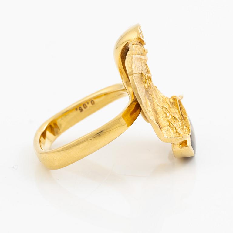 A ring, 18K gold with a fancy-cut smoky quartz and round brilliant-cut diamonds.