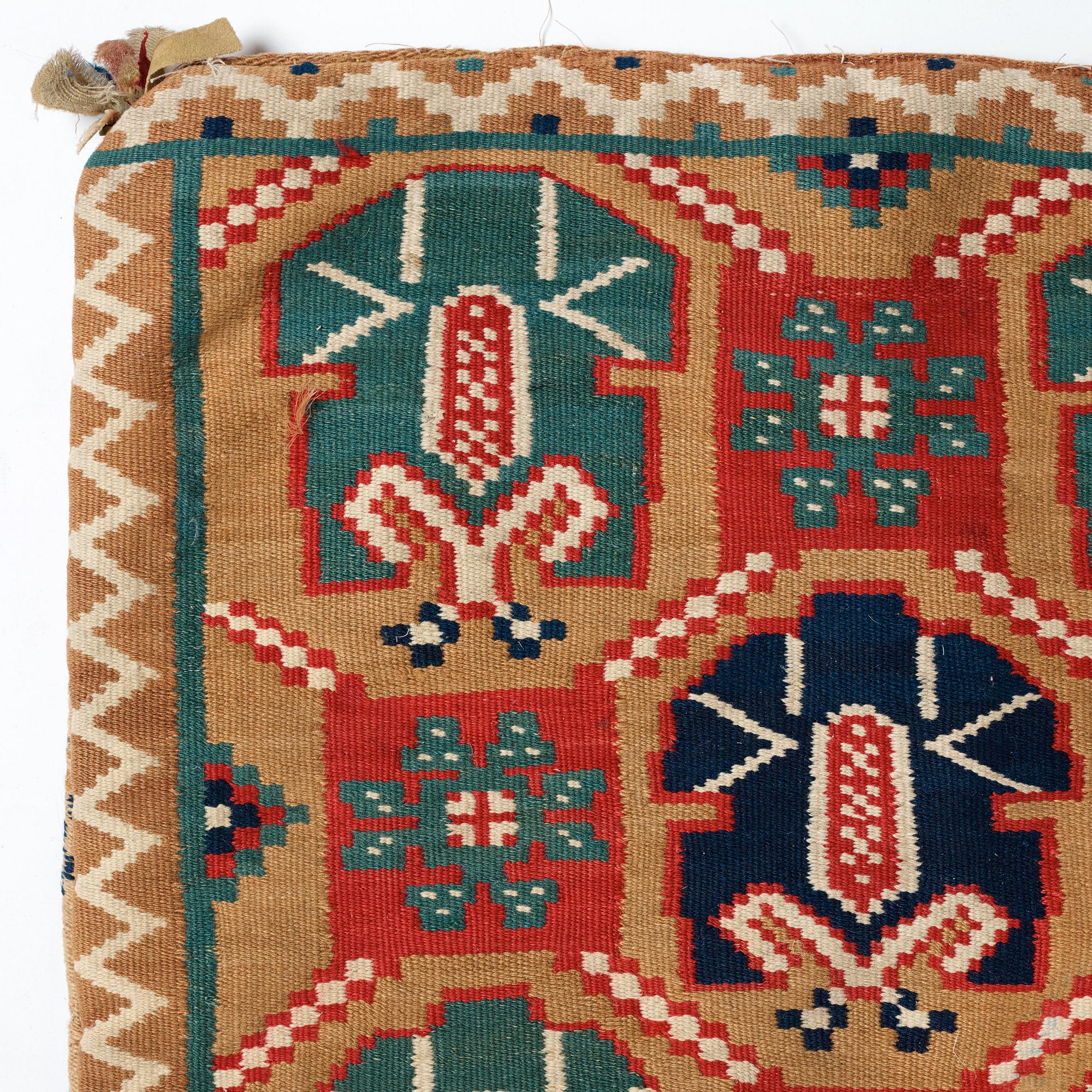 A CARRIAGE CUSHION, "Palmetter och blommor", double interlocked tapestry, ca 105 x 54,5 cm, Scania, Sweden,