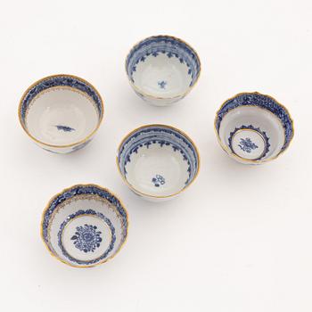 A set of nine gilt and blue and white cups with saucers, Qing dynasty, Qianlong (1736-95).