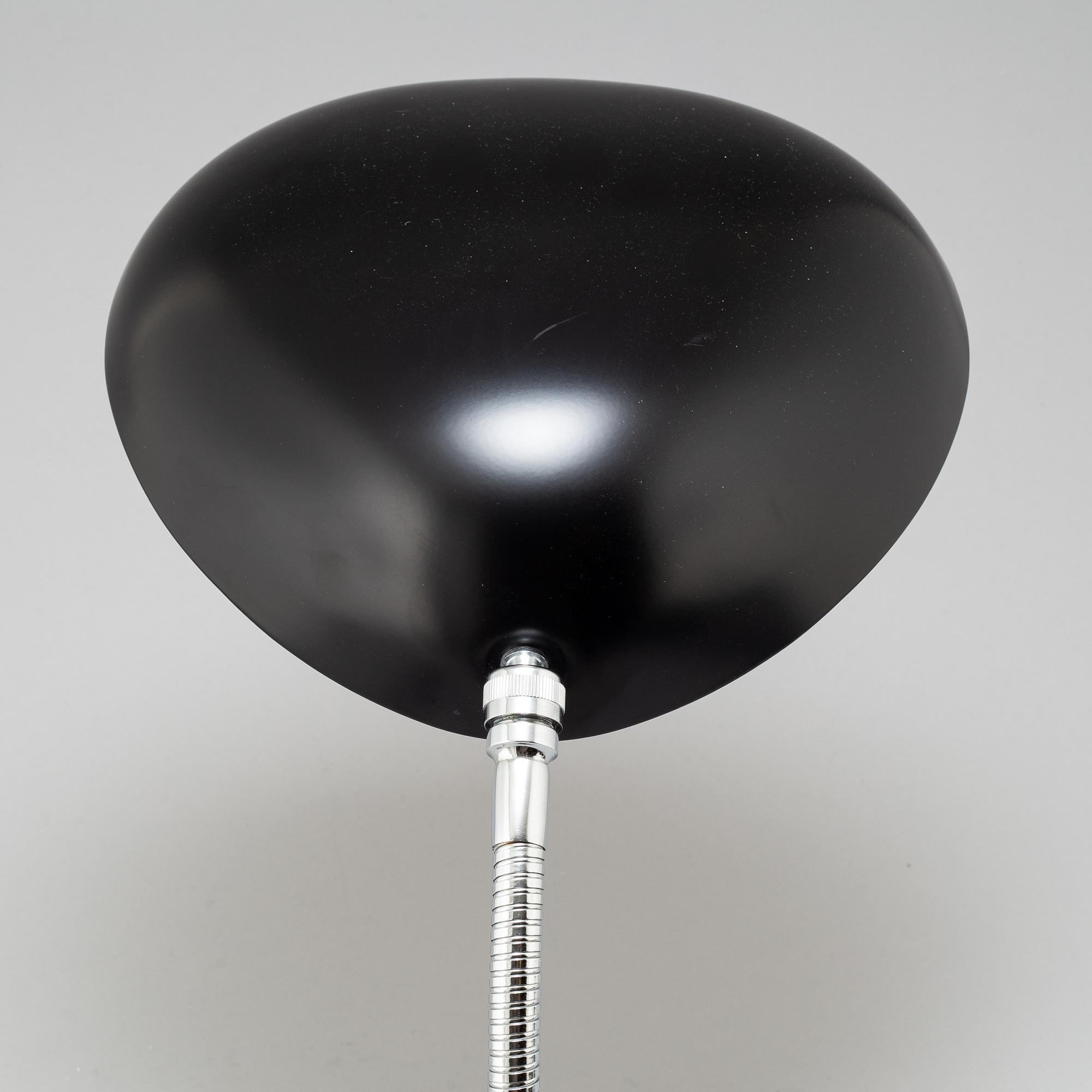 A 'Cobra' table lamp by Greta Magnusson Grossman, Gubi.