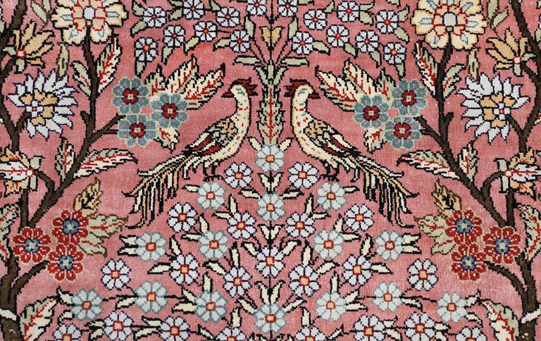 An oriental silk rug, approx. 155 x 93 cm.