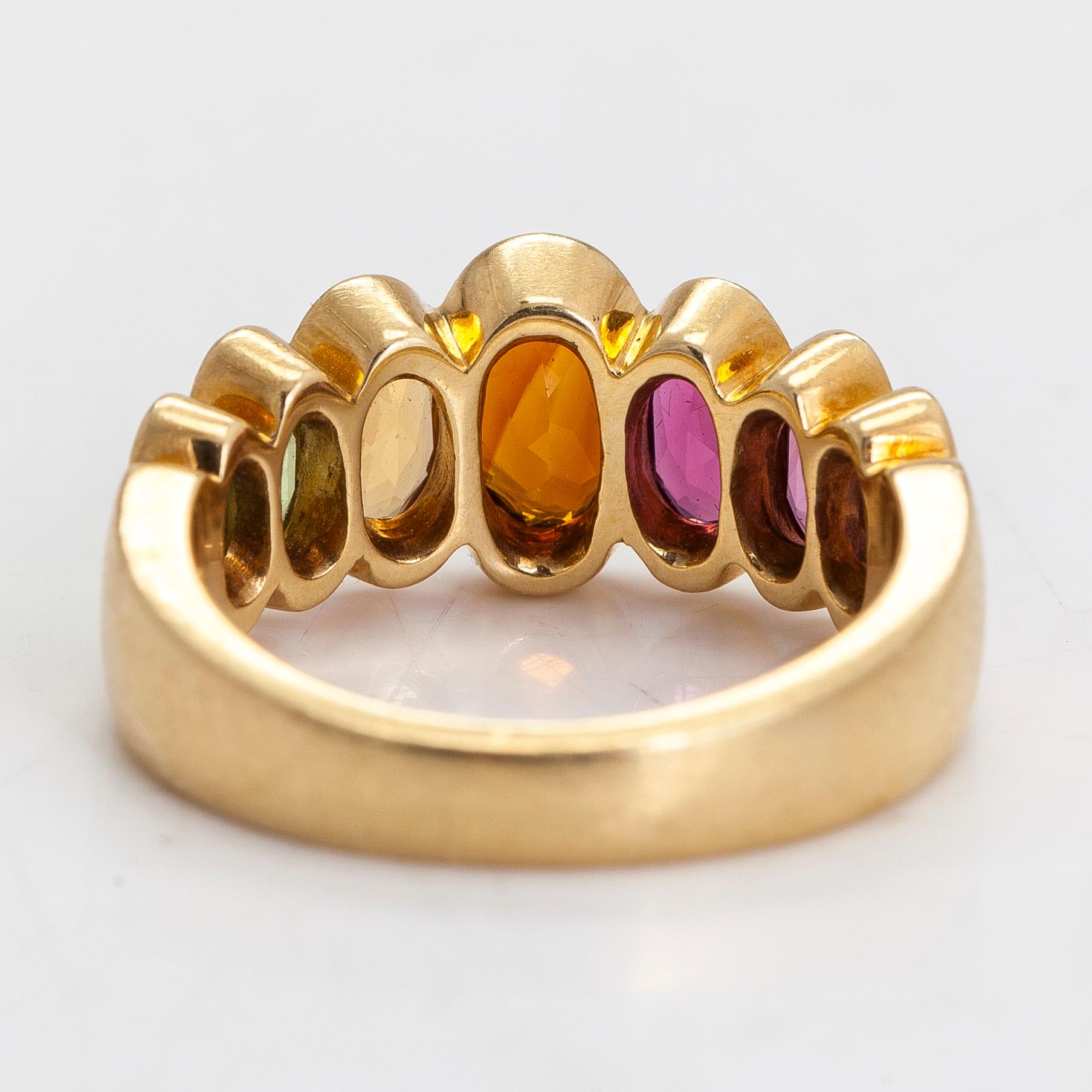 An 18K gold ring, with multi-coloured stones.