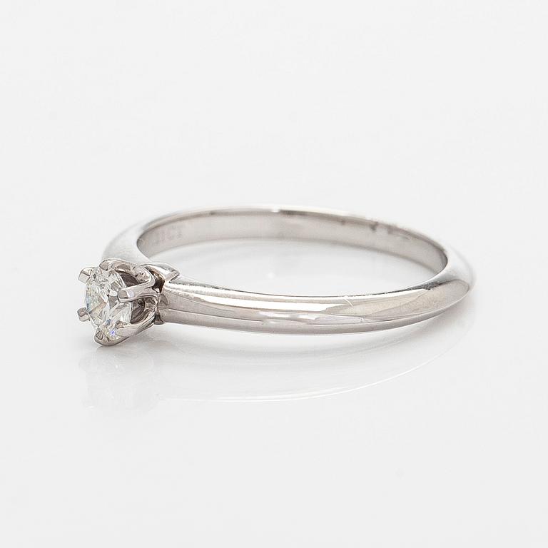 Tiffany & Co, a platinum solitaire ring with a brilliant-cut diamond.