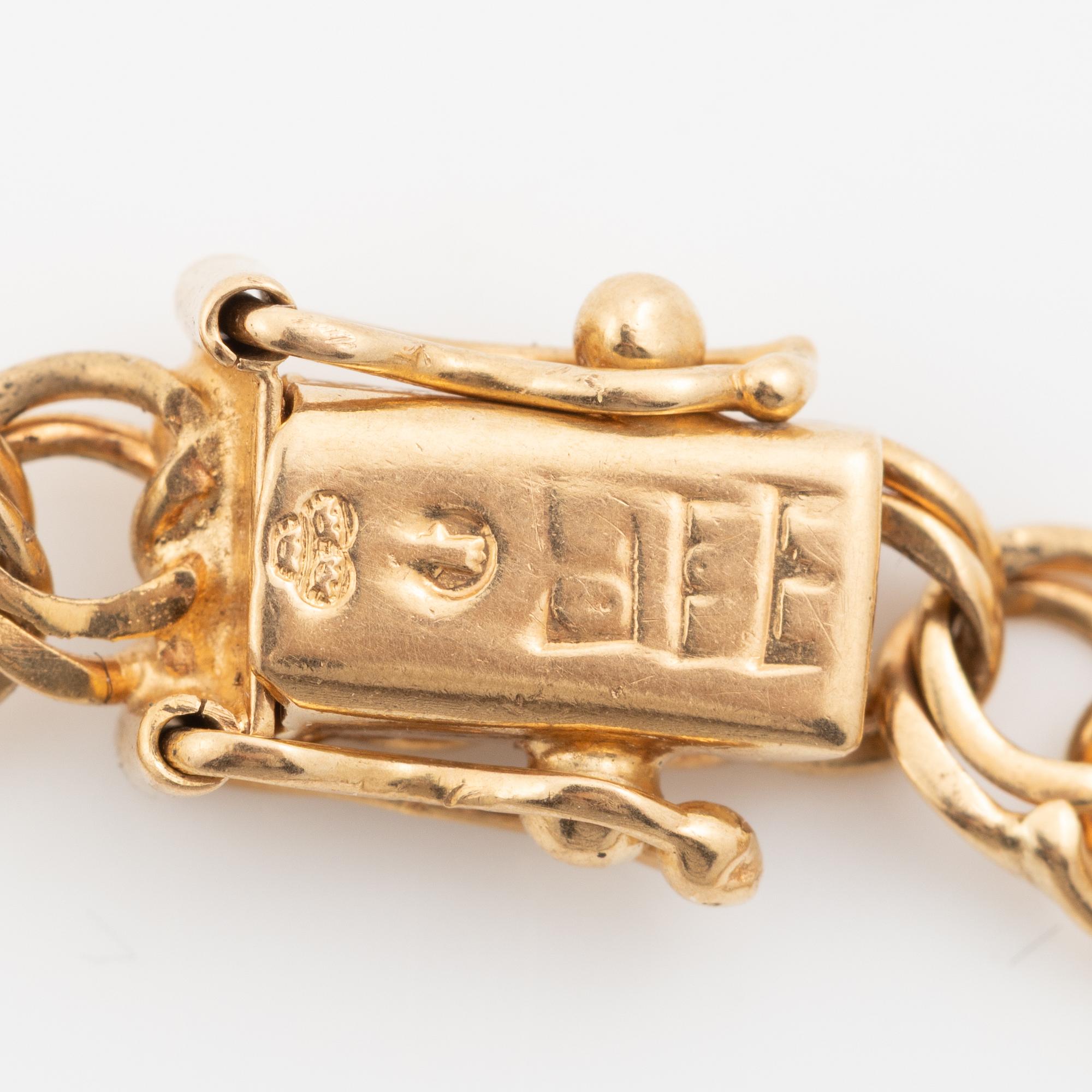 Bracelet, 18K gold bismarck link. With charms.