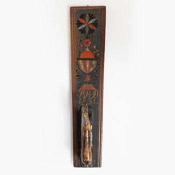 A painted wooden mangle board, dated 1831.