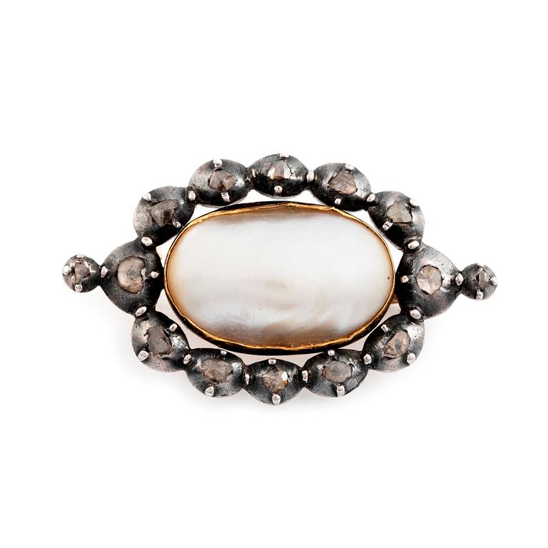 A silver and gold brooch set with a half pearl and rose-cut diamonds.