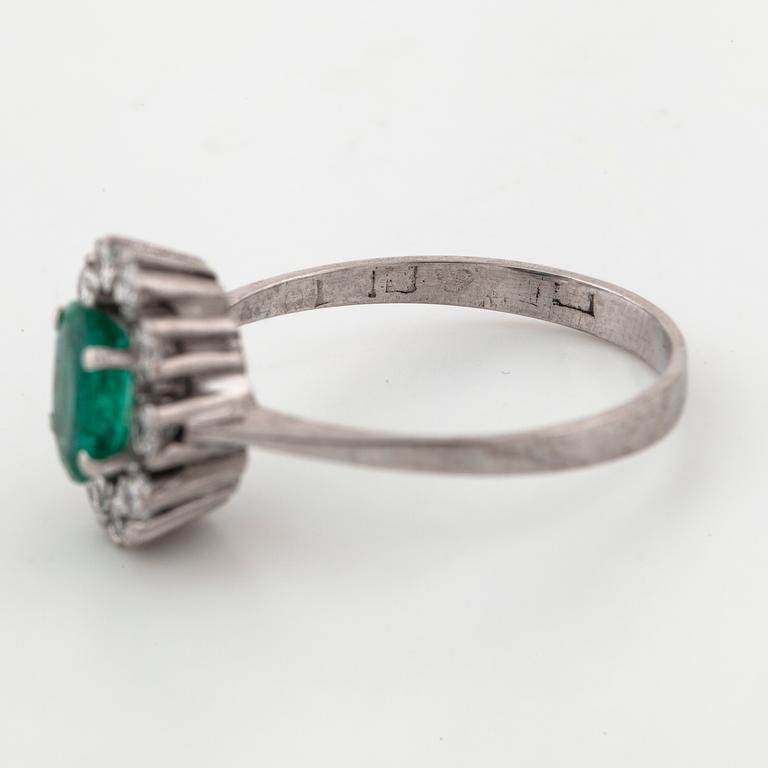 A emerald and brilliant cut diamond ring.