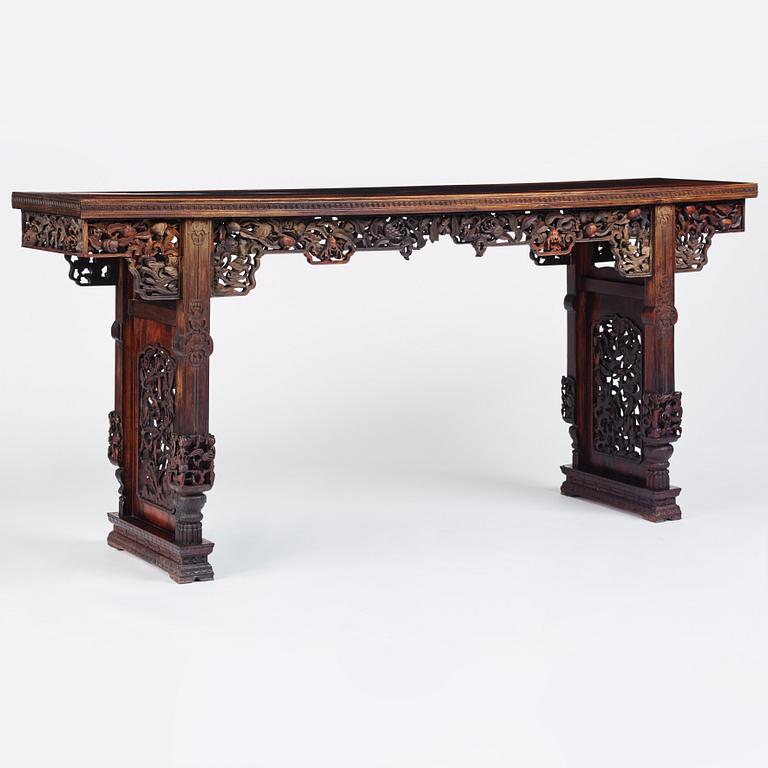 A massive zitan recessed-leg long table 'Jiaotousun Qiotouan', Qing dynasty, 19th century.