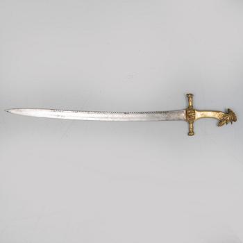 An early 19th Century Napoleonic rooster head sword. Curved blade with saw back marked Manufacture de Klingentahl Coleau.