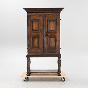 A Baroque style cabinet on later stand, first part of the 18th Century.