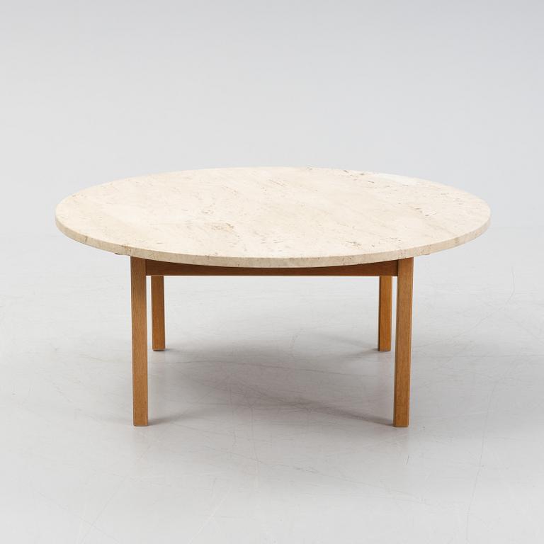 An oak coffee table with a later travertine top.