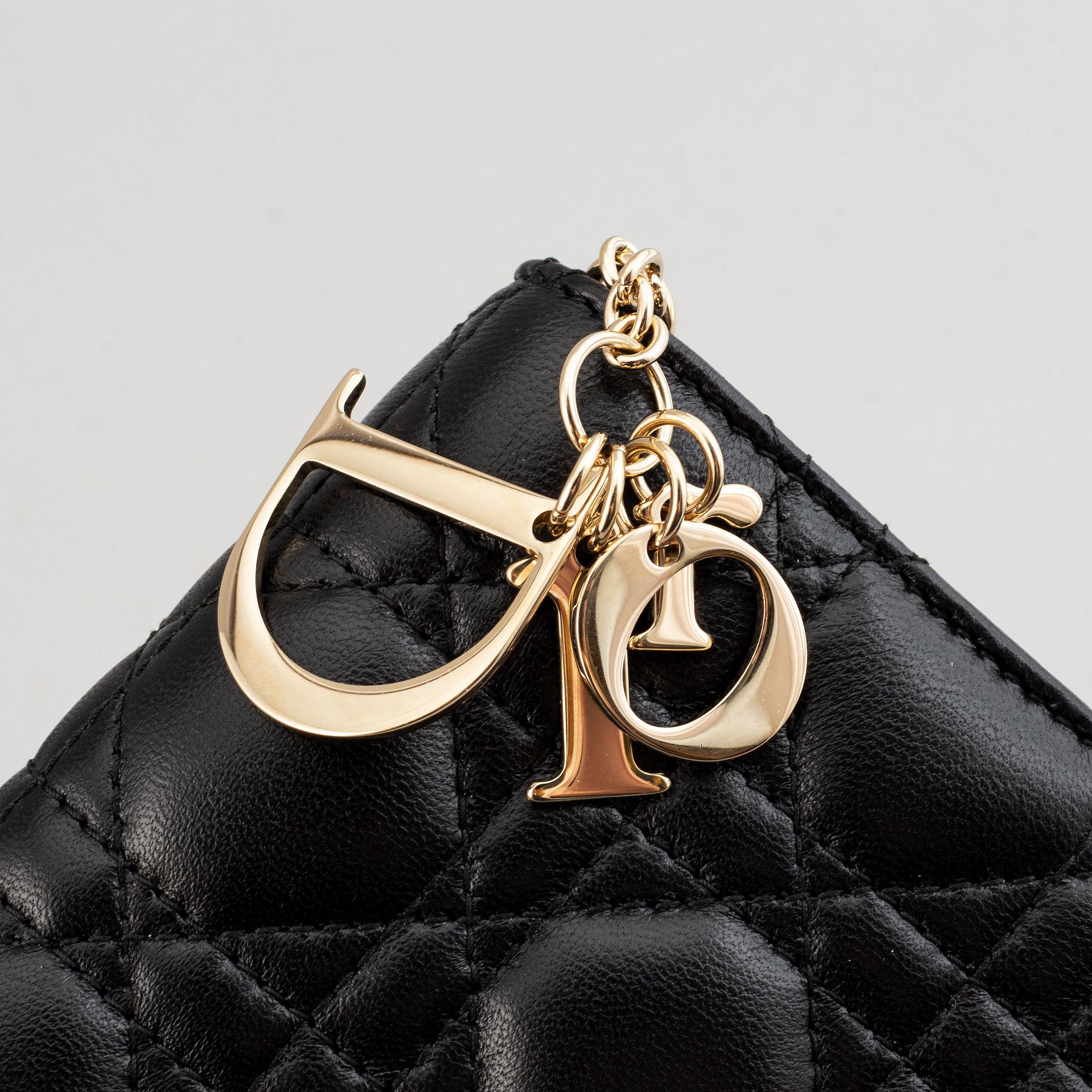 Christian Dior, a quilted leather handbag/clutch.