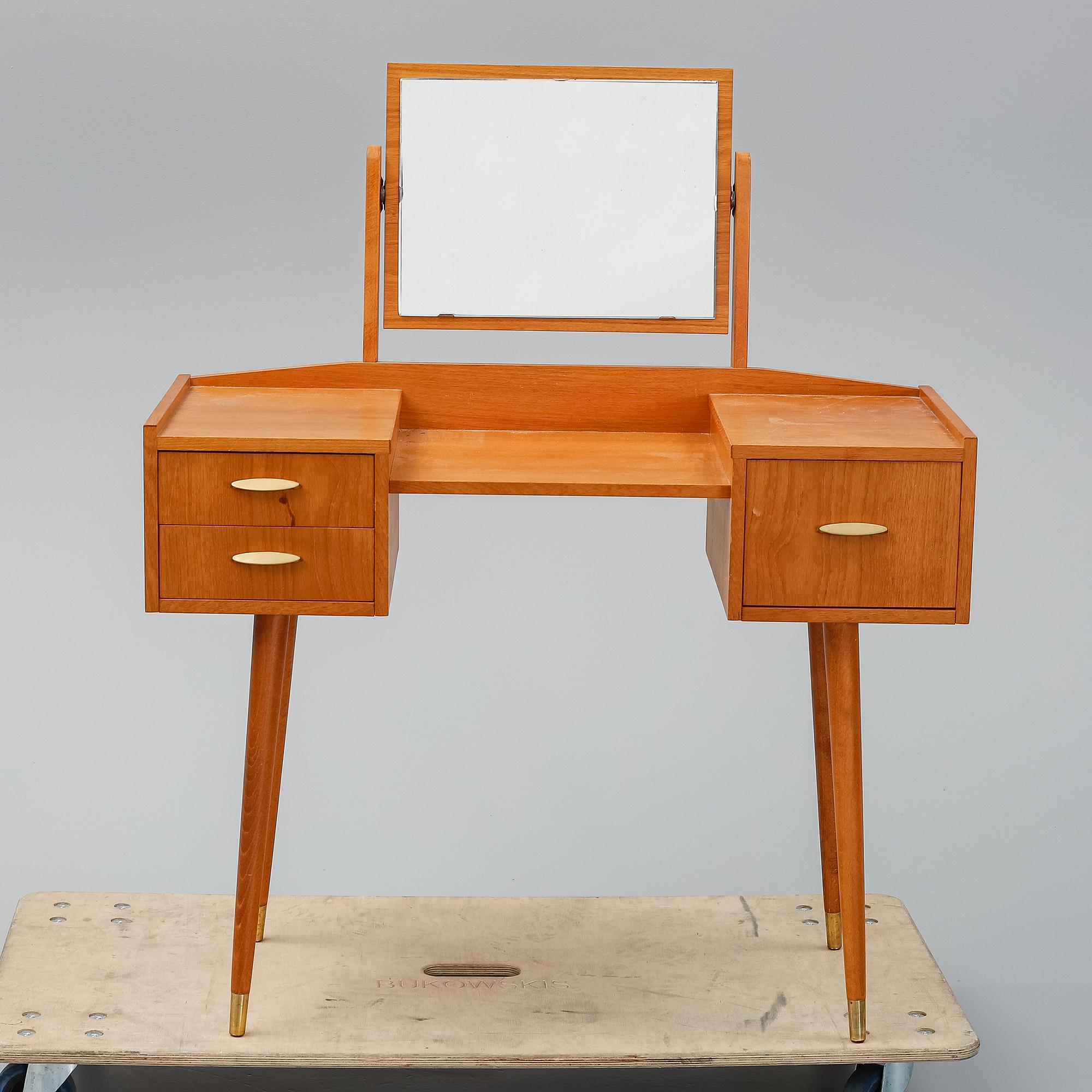 A teak makeup-table from the mid 20th century.