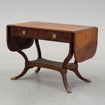 An Empire style mahogany  center table from around the year 1900.