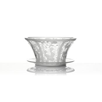 Simon Gate, an engraved Swedish Grace glass bowl on a plate, Orrefors, Sweden 1926, model 147.