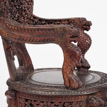 A pair of carved 'blackwood' armchairs, Bombay presidency, British Raj, circa 1880.