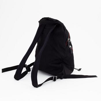 Gucci, a black canvas backpack.