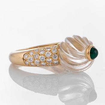 A Boucheron ring set with a carved rock crystal, a cabochon-cut emerald and round brilliant-cut diamonds.