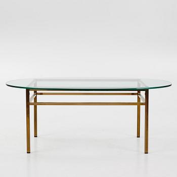 A 1970's glass and brass coffee table.