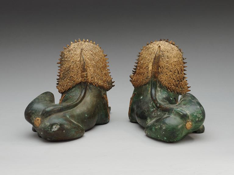 A pair of Burmese/Thai gilt bronze figures of buddhist lions, late 19th Century.