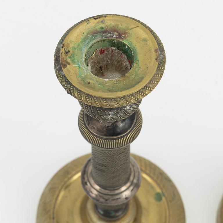 A pair of bronze Empire style candlesticks, 20th Century with older parts.