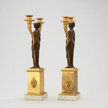 A pair of late Gustavian circa 1800 gilt and patinated bronze two-light candelabra.