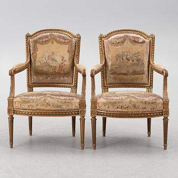 A pair of Louis XVI-style armchairs, late 19th century with 18th century fabric.
