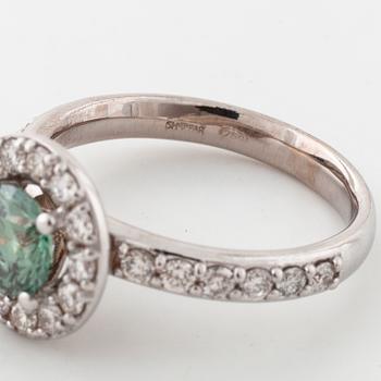 A treated green diamond and briliant cut diamonds.
