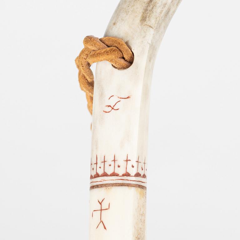 A reindeer horn back scratcher, unidentified signature.