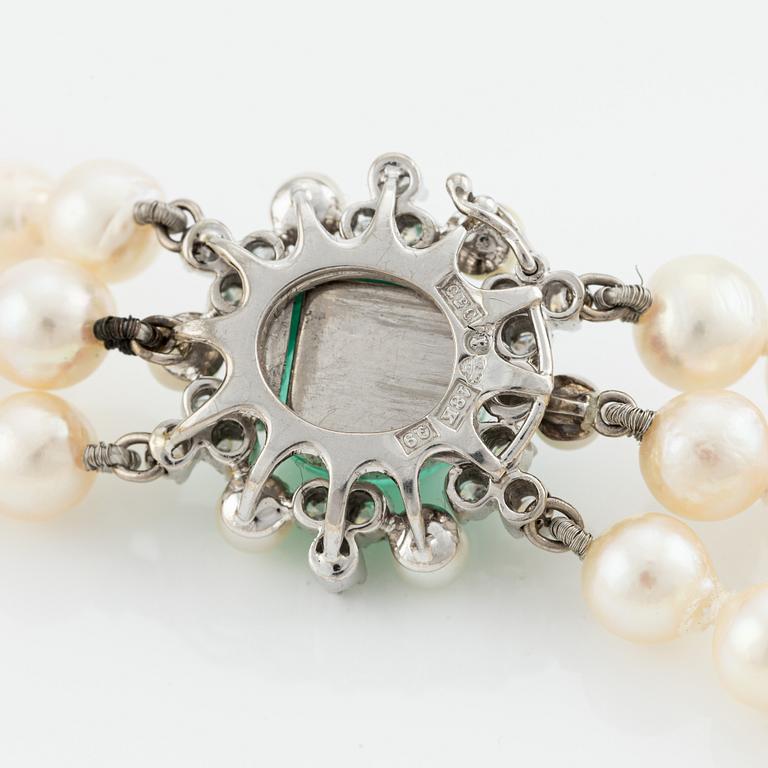 Necklace, three-strand, cultured pearls, clasp by Carlman 18K white gold with cabochon-cut emerald, pearls, and diamonds.