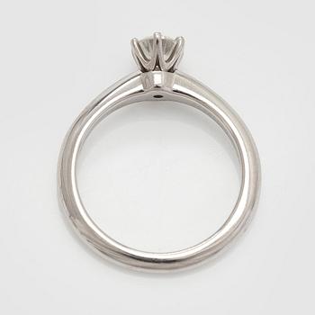 Tiffany & Co, a platinum solitaire ring with a brilliant-cut diamond.