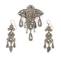 Demi parure, a pair of earrings, and a brooch, with so-called steel diamonds, 19th century.