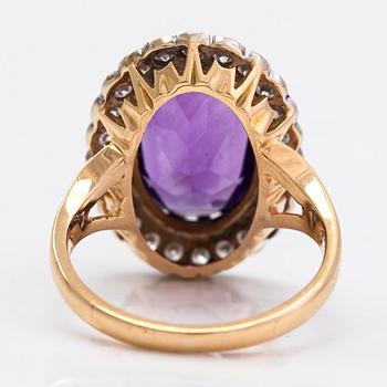 An 18K gold ring, with an oval faceted amethyst and diamonds totaling approximately 0.60 ct. Finnish marks.