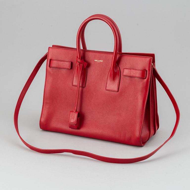 Saint Laurent, a red leather 'Sac du Jour Small' bag.