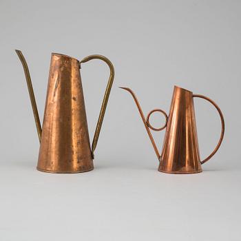 Eight 19th and 20th century copper and brass watering cans.