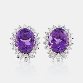 1285. A pair of amethyst and diamond, circa 1.95 cts, earrings.