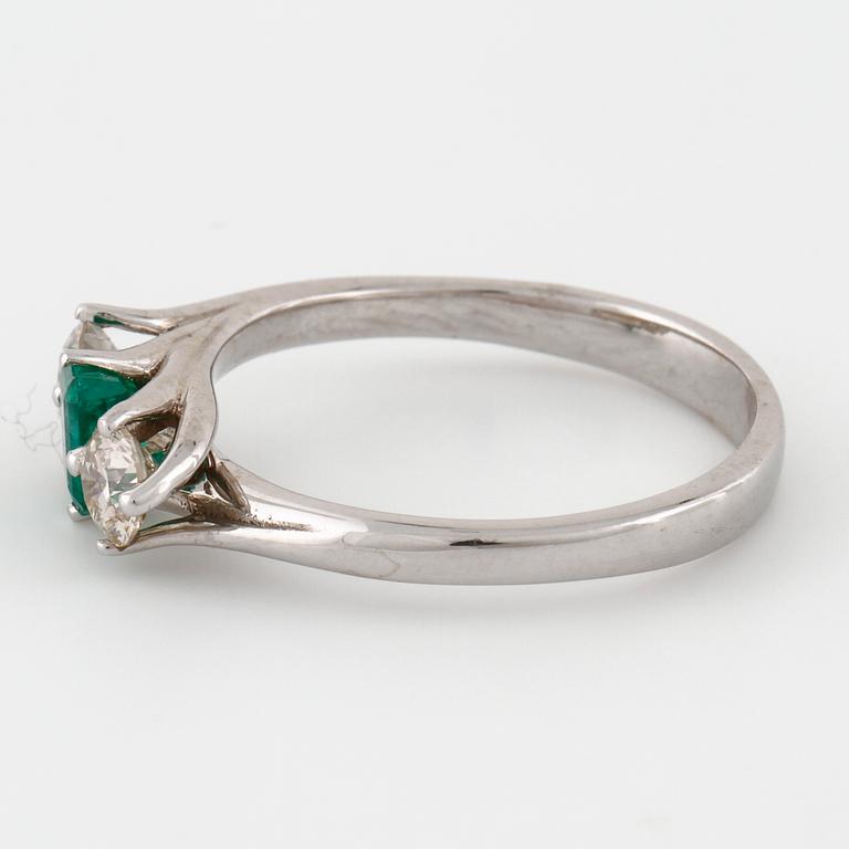 A emerald and brilliant cut diamond ring.