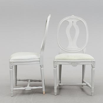 A Gustavian style dining table and ten chairs, 20th century.