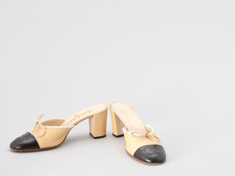 A pair beige and black leather slip-in by Chanel.