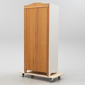 An early 20th Century painted clothes cabinet.
