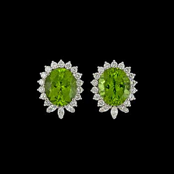 1010. A pair of peridote, tot, 13.82 cts, and brilliant cut diamond earrings, tot. 1.95 cts.