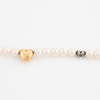 Ole Lynggaard 18K gold clasp in the shape of a heart with a cultured freshwater pearl necklace with a silver heart.