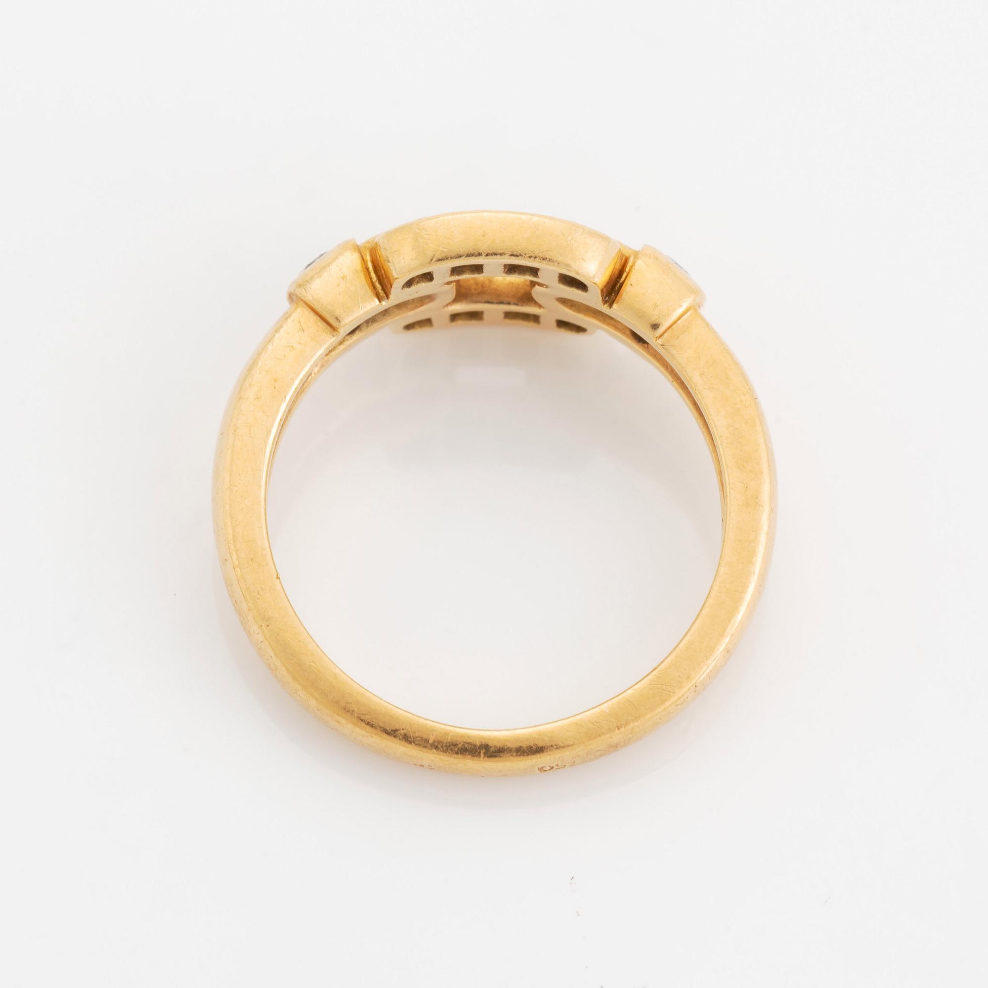 An 18K gold Cartier ring set with round brilliant-cut diamonds.