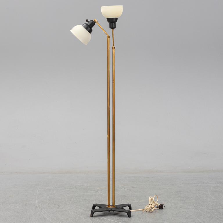 A 1950s brass and glass floor lamp.