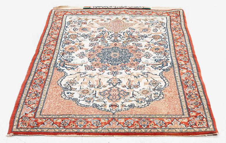 A semi-antique Isfahan rug, central Iran, part silk, signed (Mohammed) Seirafian, c. 120 x 70 cm.