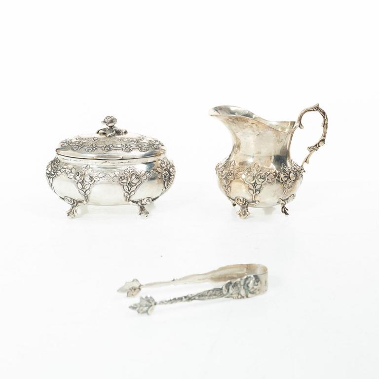 A silver sugar bowl, creamer and sugar tongs, 20th century.