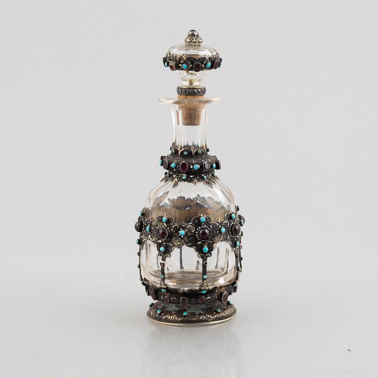 Flask with stopper, glass with mounts of partially gilded silver, late 19th century.