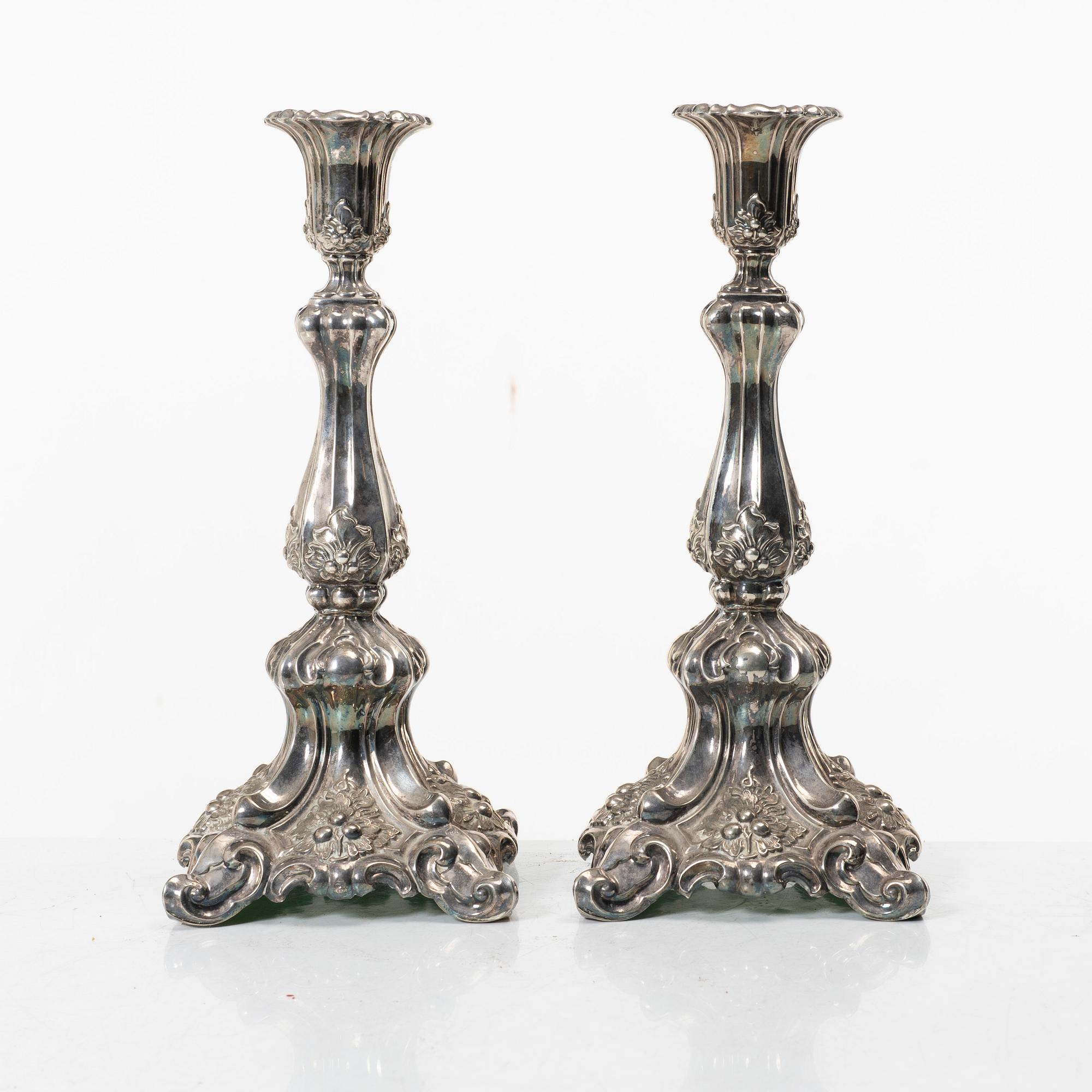 A pair of rococo-style silver candle sticks, early 20th century.