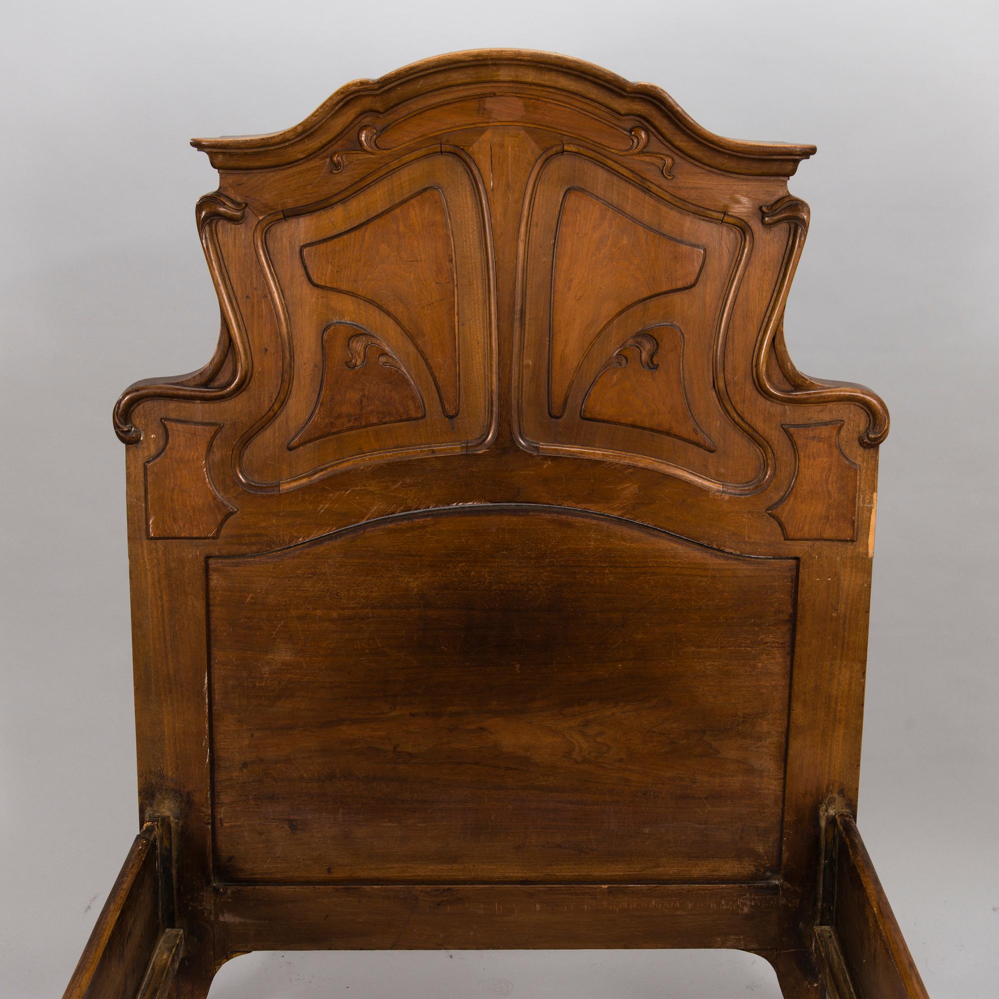 A pair of early 20th Century art nouveau style beds.