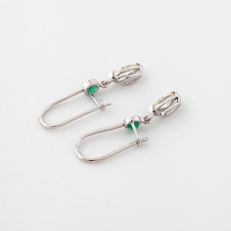 A pair of emerald and marquise cut diamond earrings.